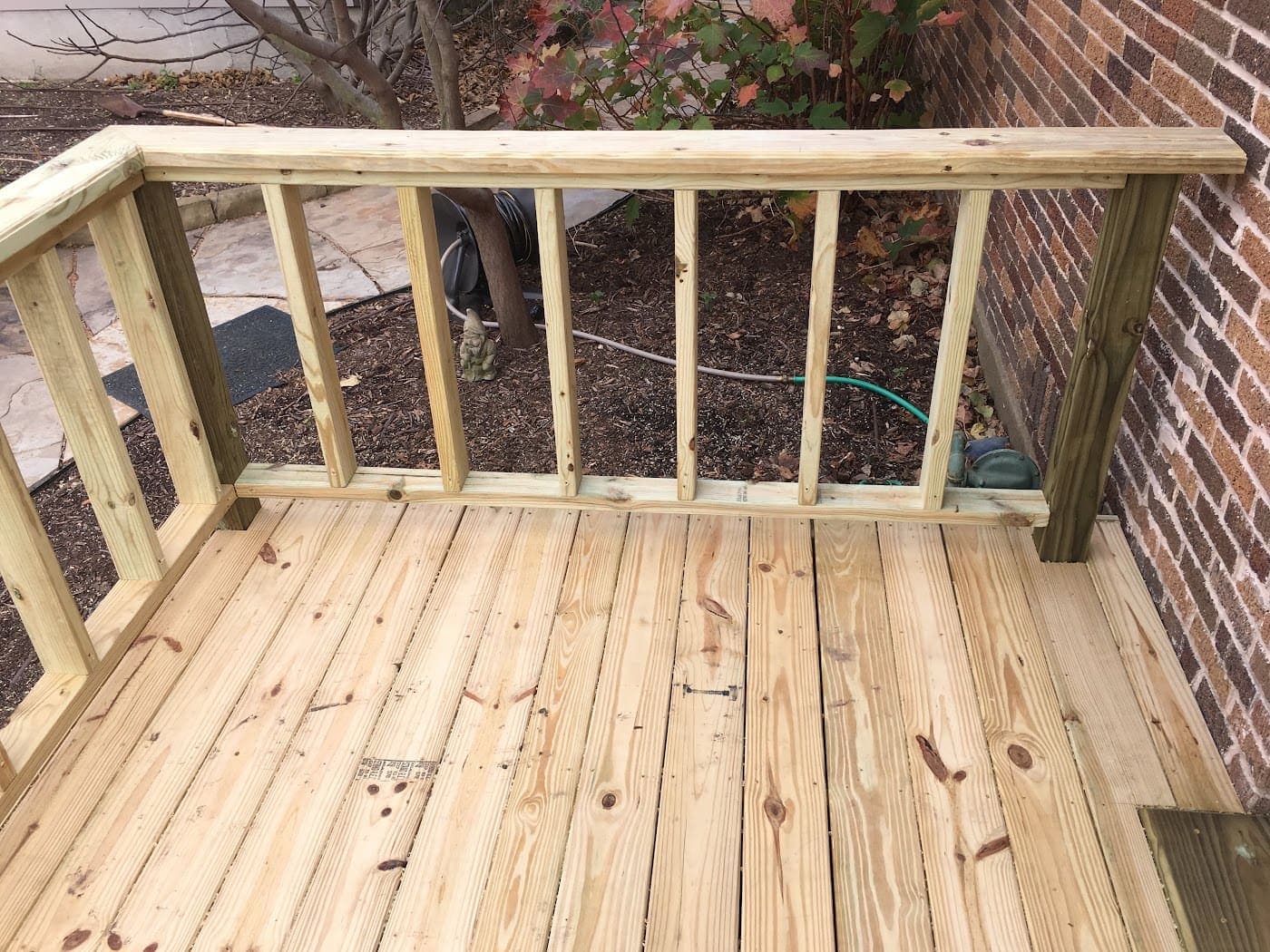 Deck with a built railing overlooking the yard