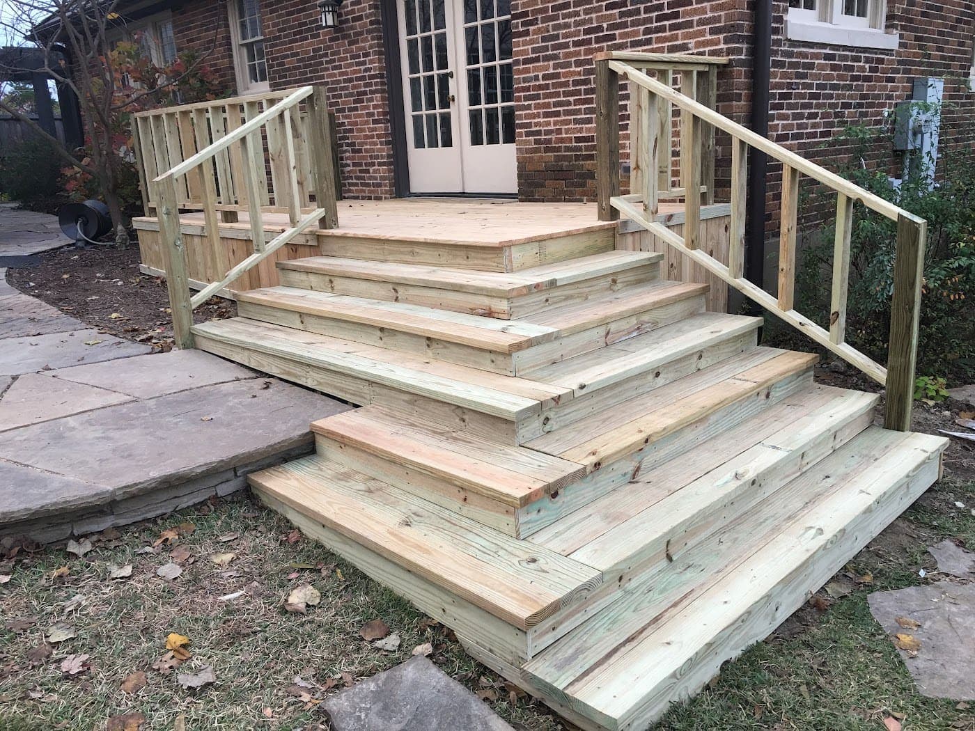 Multi-tier deck stairs leading up to french doors