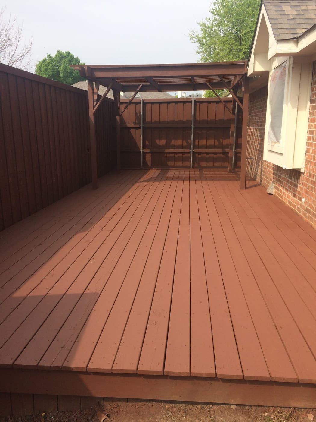 Stained deck under a covered patio structure