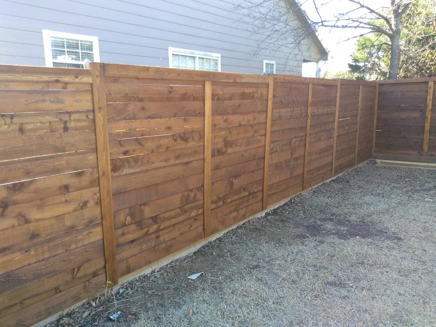 Horizontal cedar fence in Plano, TX — metal post frame with 1x6 planks
