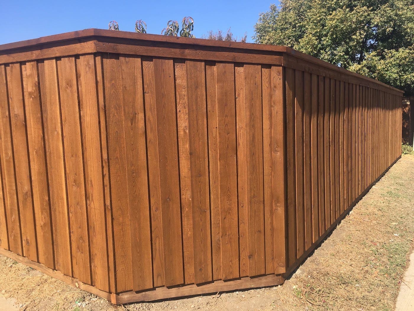 Cedar board-on-board fence with full cap trim wrapping a corner