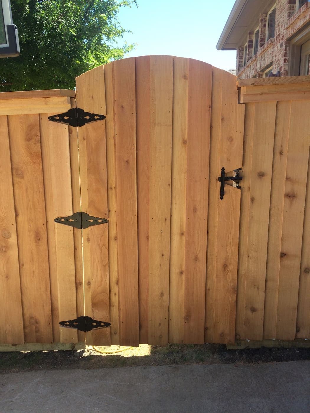 Arched-top cedar gate with black hardware