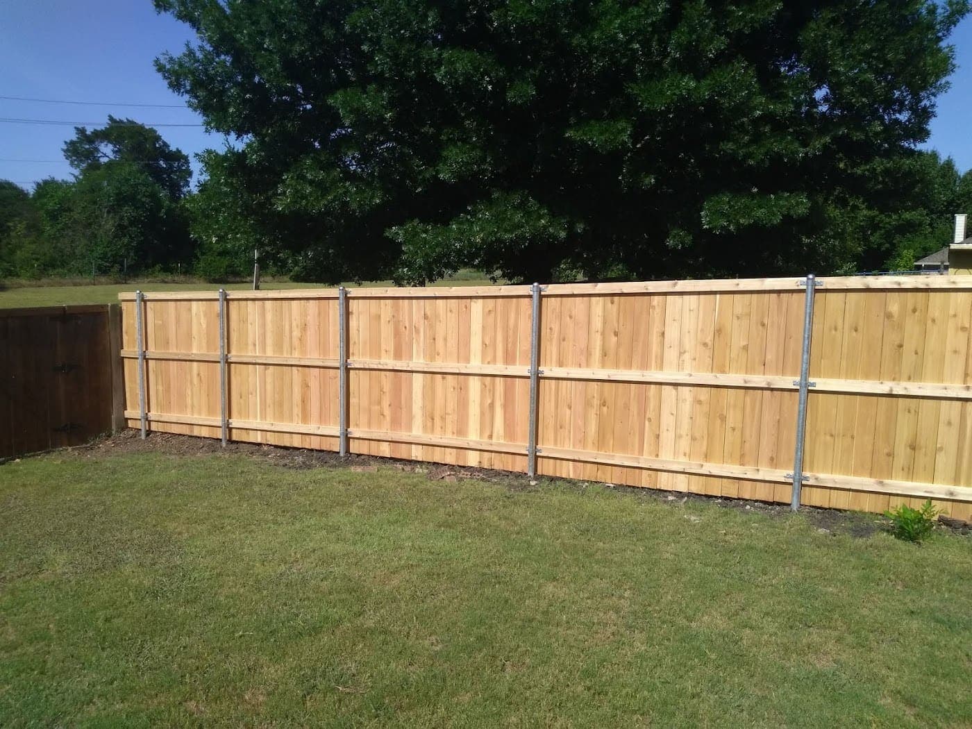 Cedar fence hung on 13-gauge heavy-duty galvanized steel posts