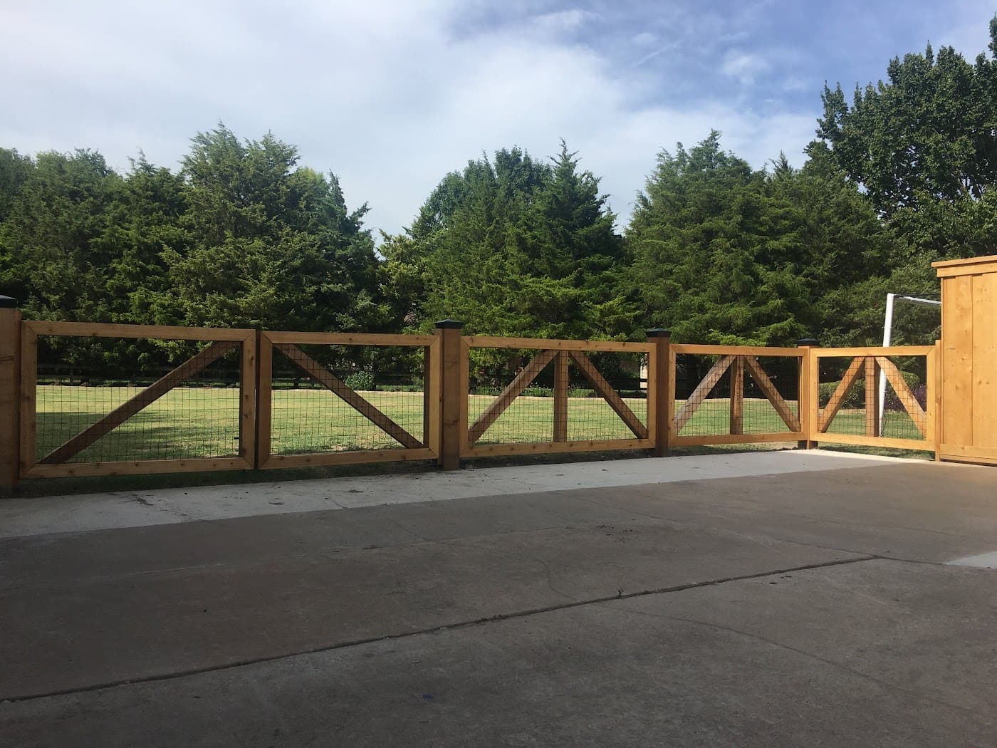 Cedar ranch-rail fence and gate at a driveway entrance