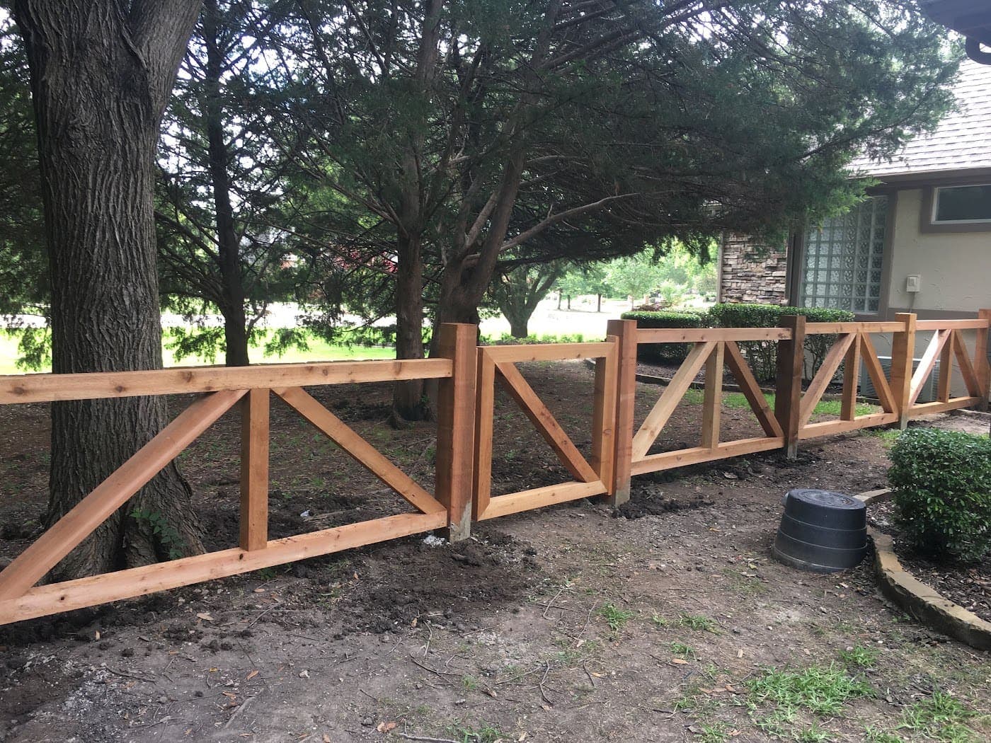 Cedar ranch-rail fence run along a property line