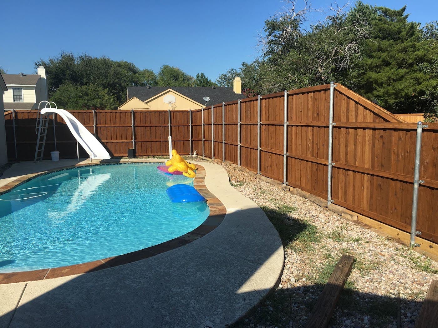 Cedar privacy fence around a backyard pool