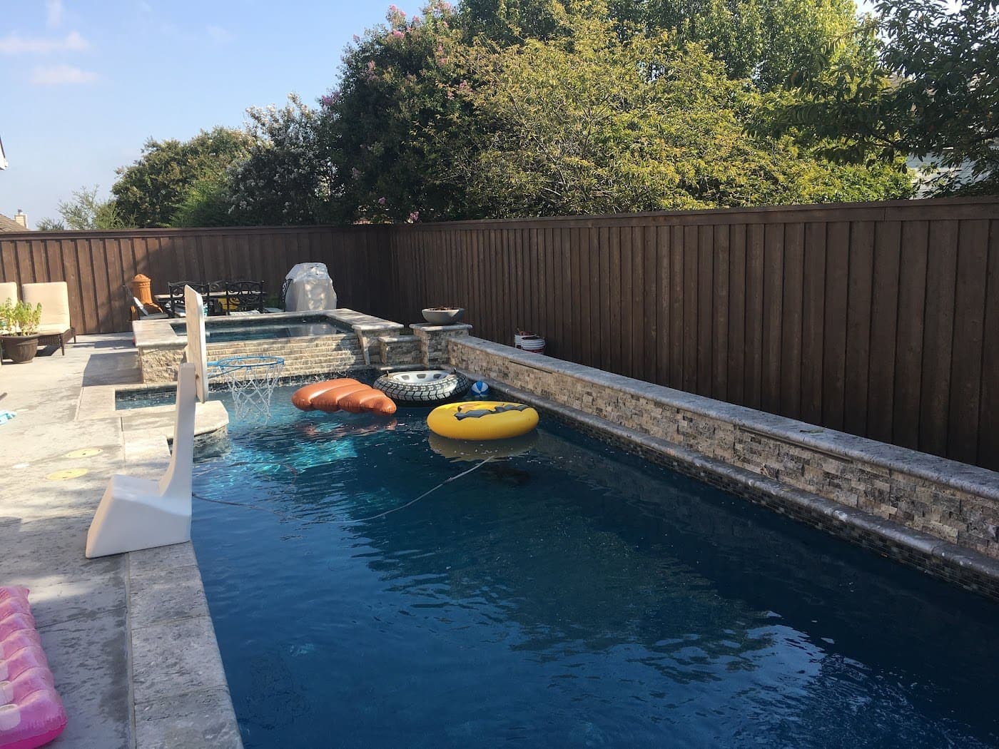 Dark-stained privacy fence enclosing a pool yard