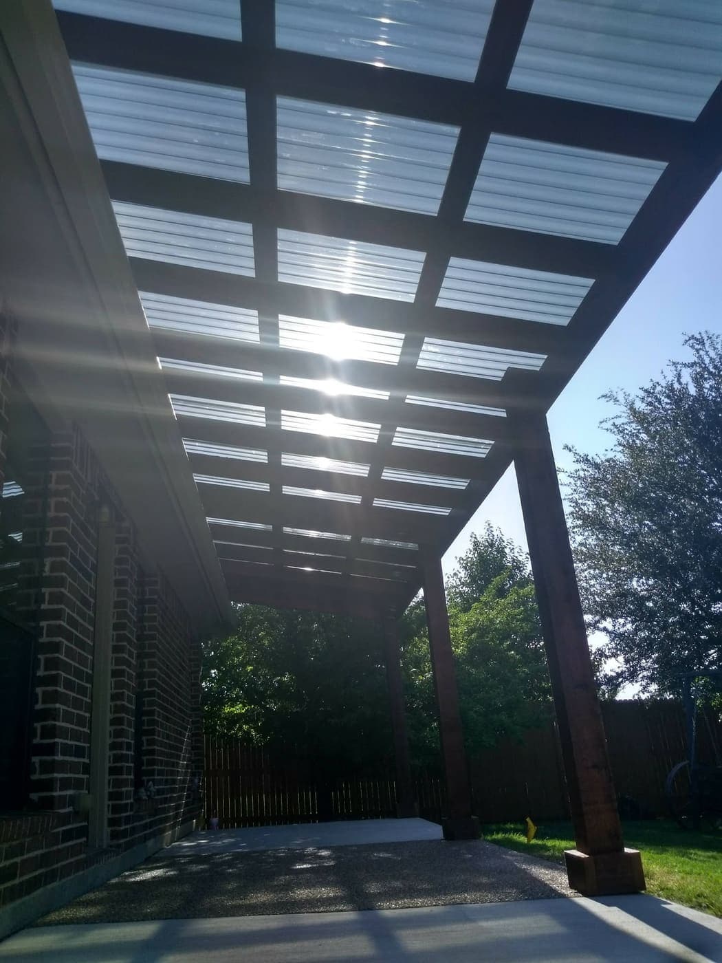 Underside of a cedar patio cover with roofing panels
